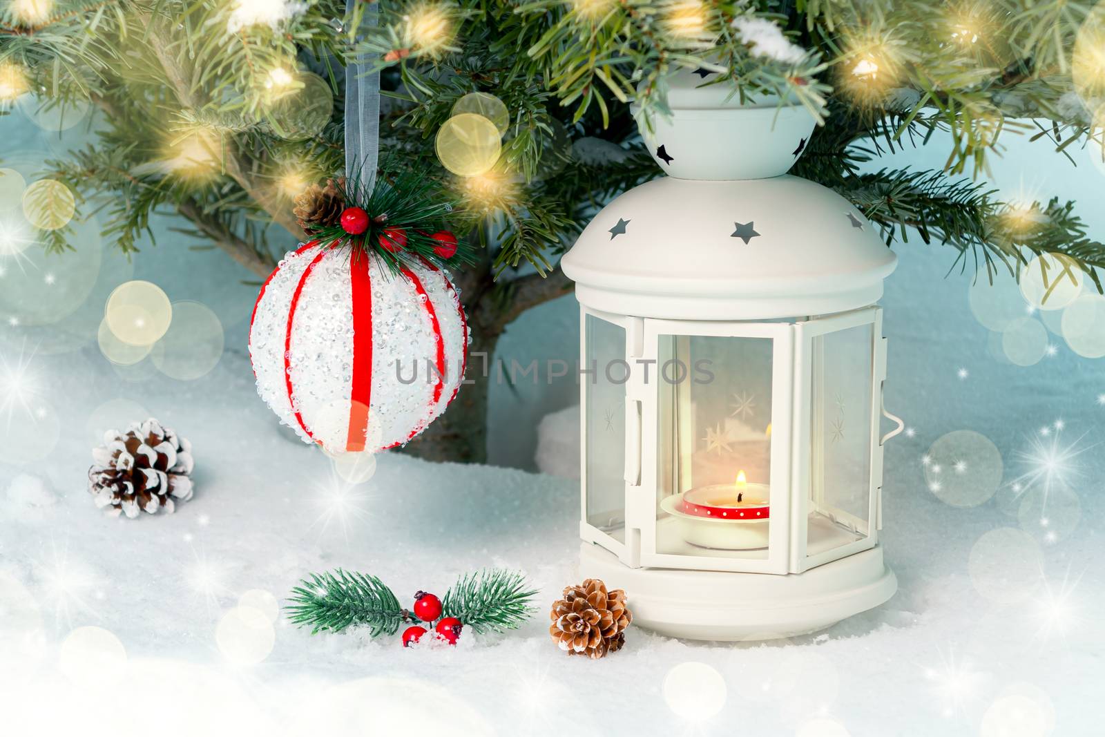 Christmas composition - a lantern with a burning candle and decorations under the Christmas tree.
