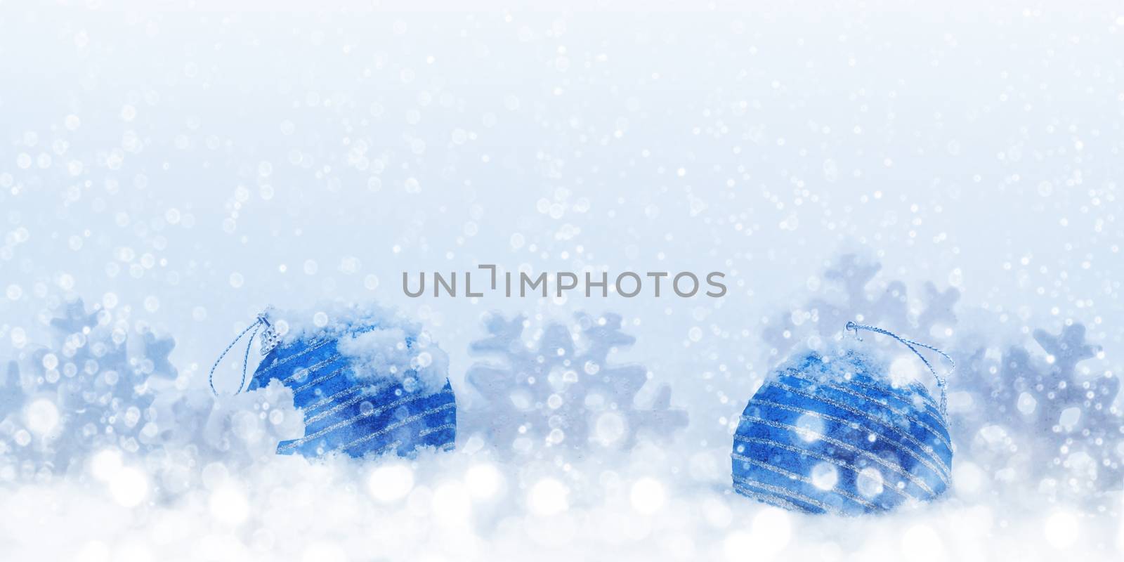 Christmas composition of blue balls and snowflakes in the snow - blank for greeting card or other design, place for text, copy space.