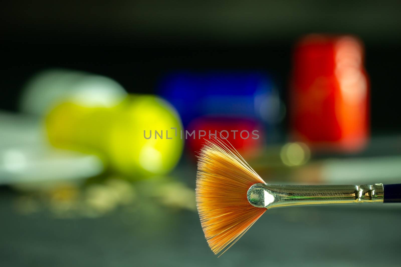 Closeup artist paint brush and poster color bottle blur backgrou by SaitanSainam