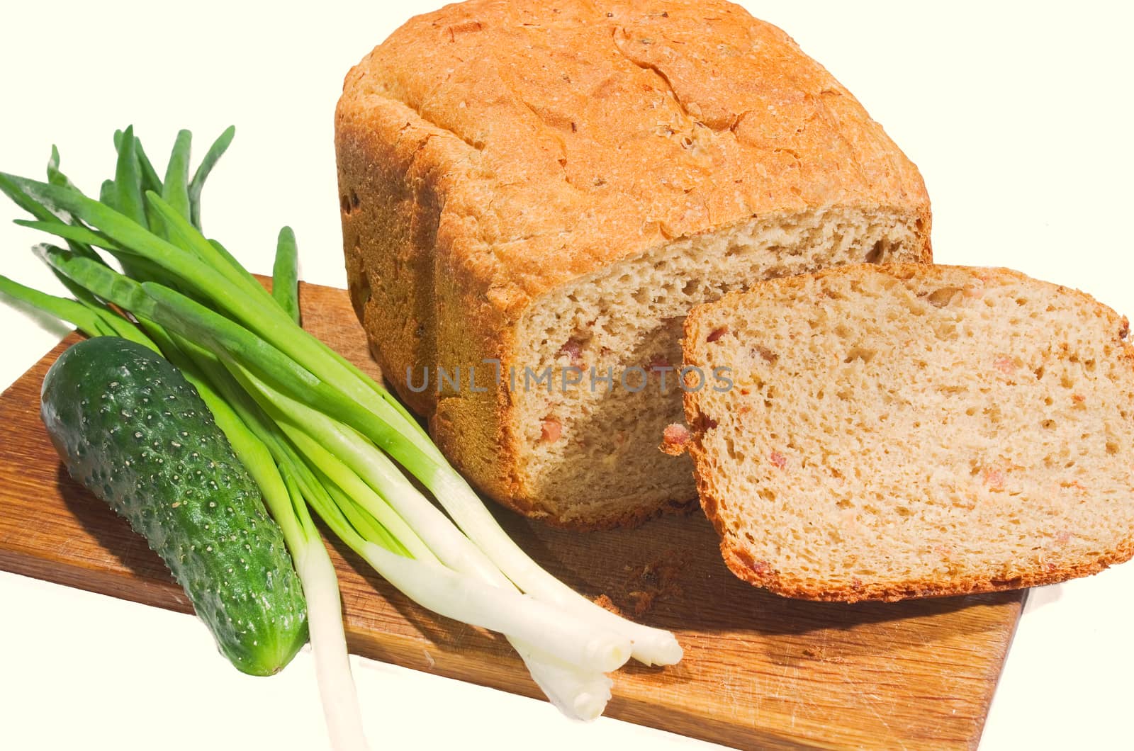 Freshly baked bread and vegetables on a white background