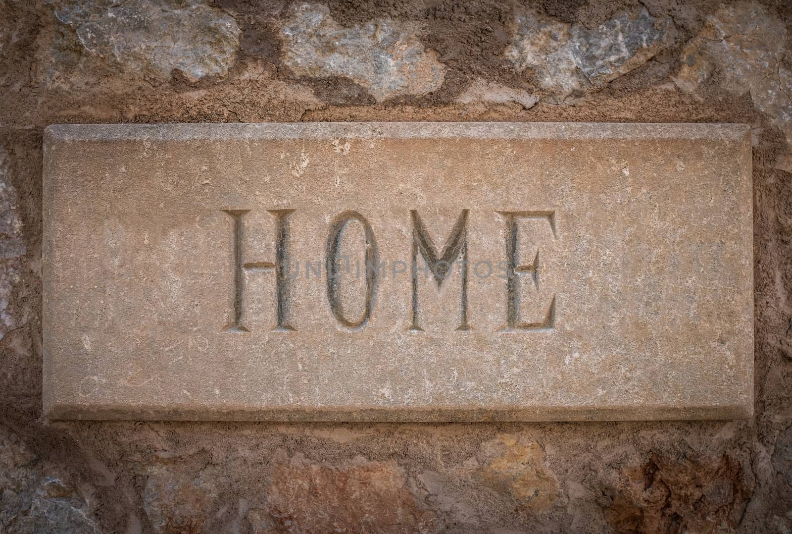 The Word Home Carved In Stone Outside A Villa In Spain