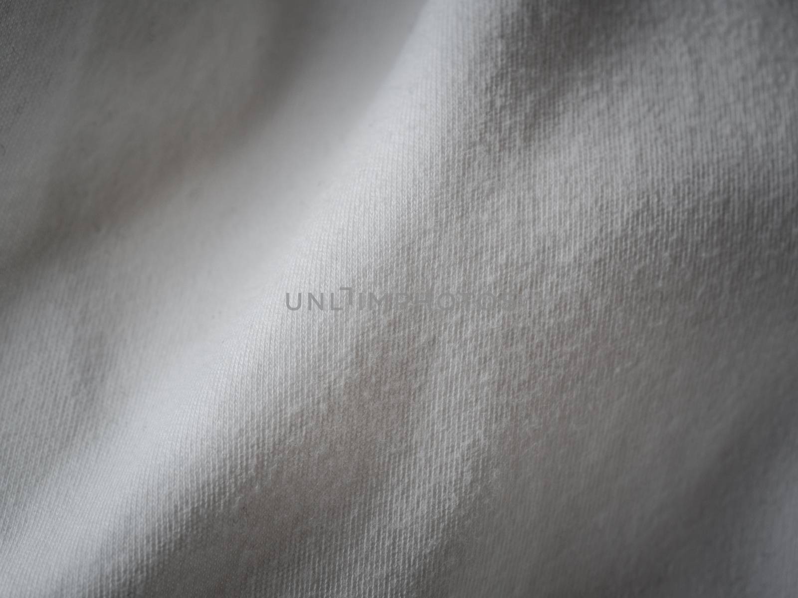 White cotton fabric texture. Clothes cotton jersey background with folds