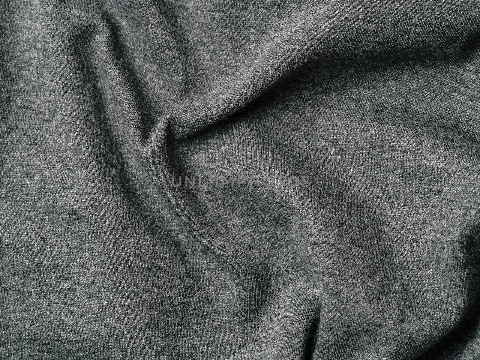 Gray cotton fabric texture. Clothes cotton jersey background with folds