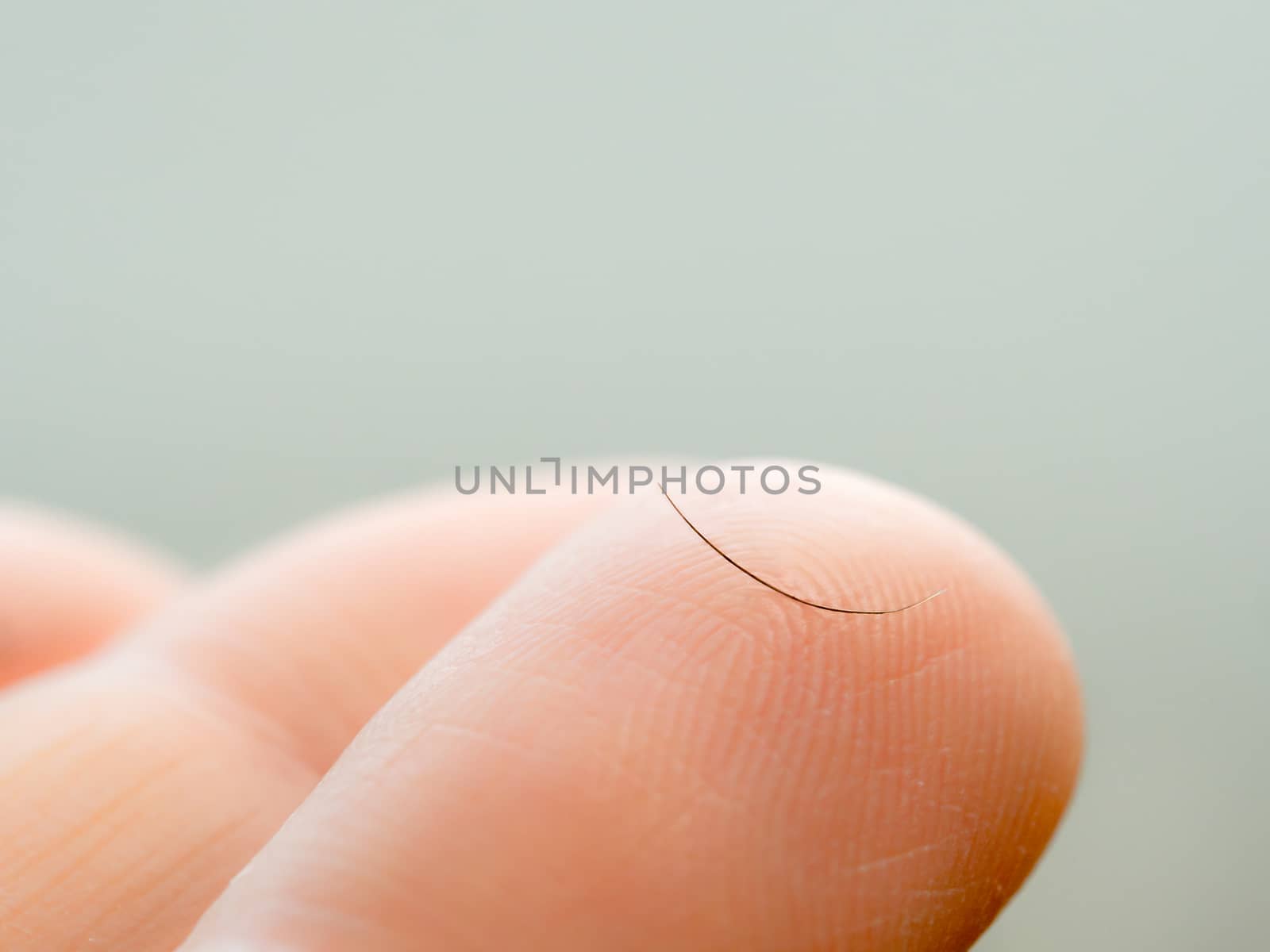 One dropped eyelash on finger, macro shoot by fascinadora