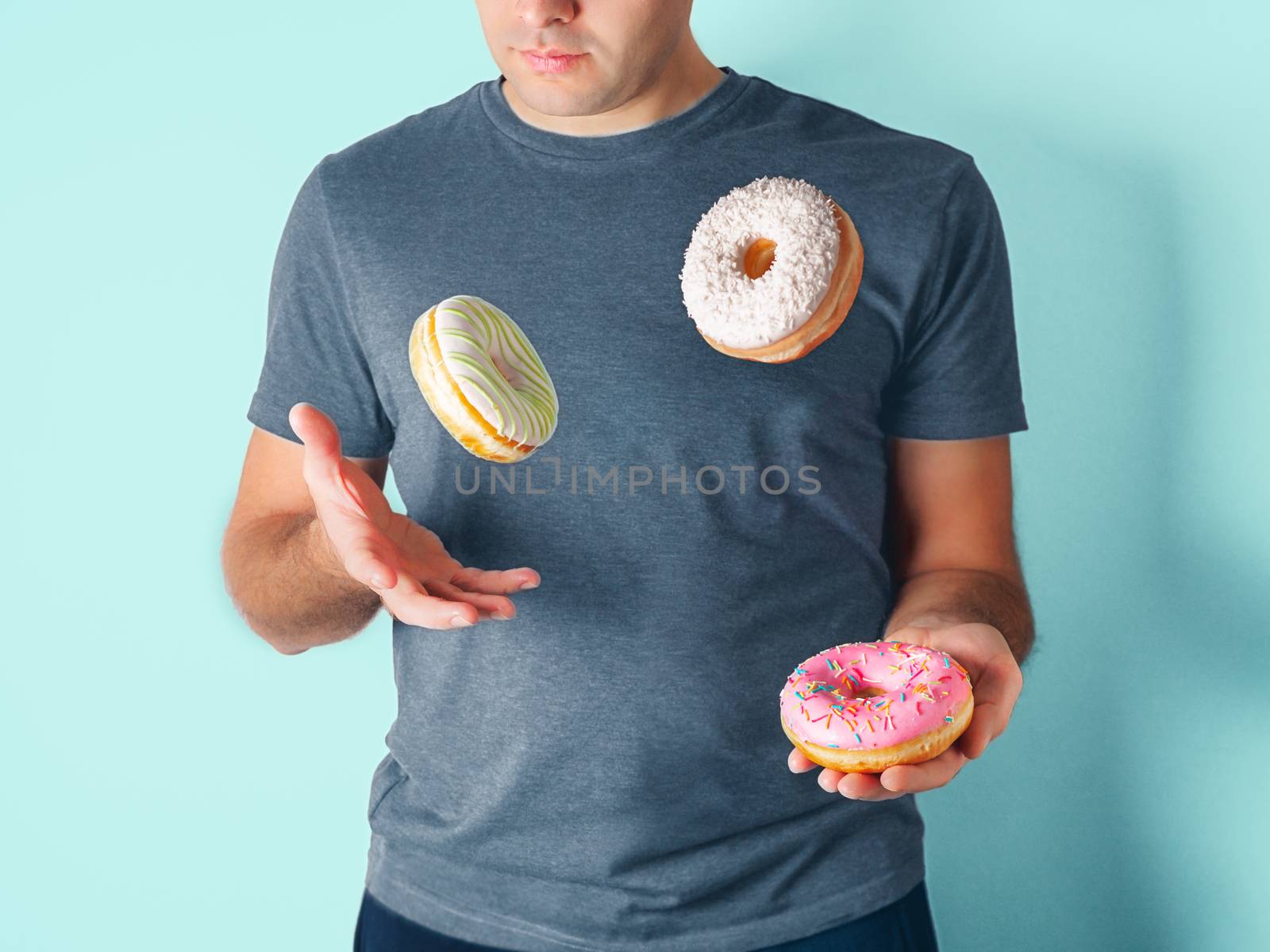 Juggler man juggles donuts on blue background by fascinadora