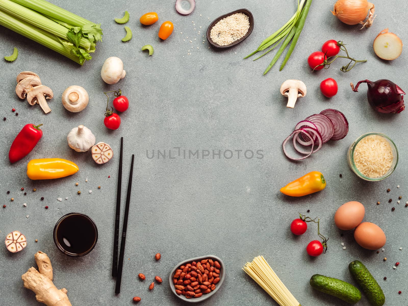 Asian food ingredients with copy space. Various of Chinese cooking ingredients and chopsticks on gray stone background. Asian food concept. Copy space for text. Top view or flat lay.