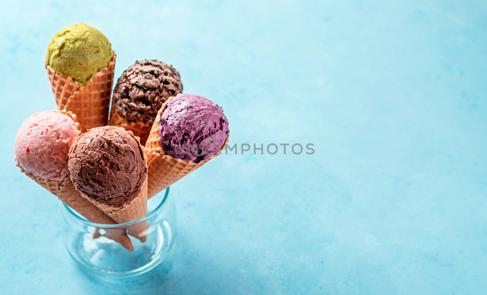 ice cream scoops in cones with copy space on blue by fascinadora