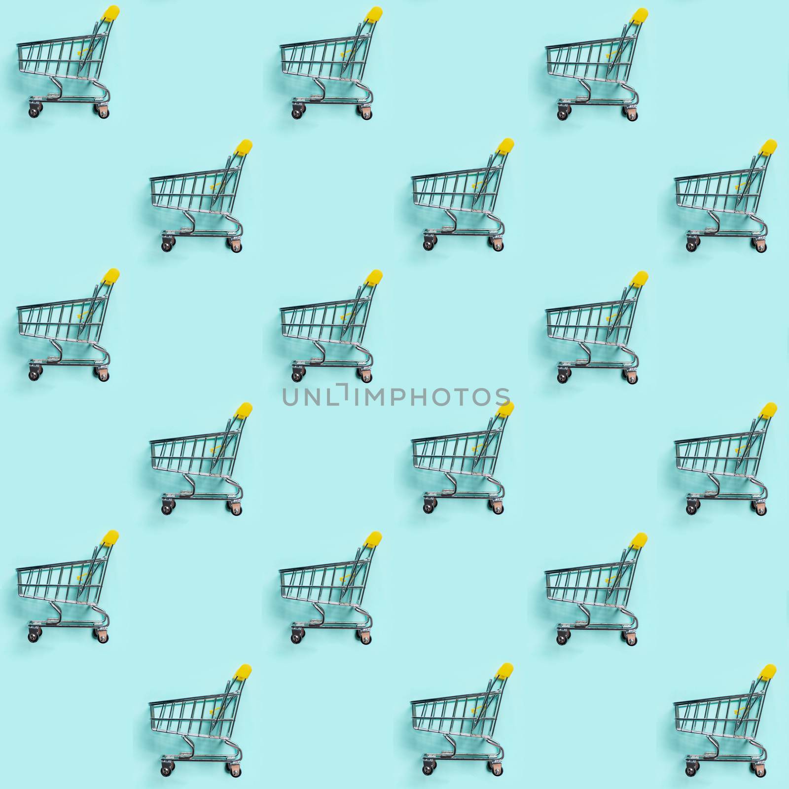 Shopping cart staggered on blue. Seamless pattern by fascinadora