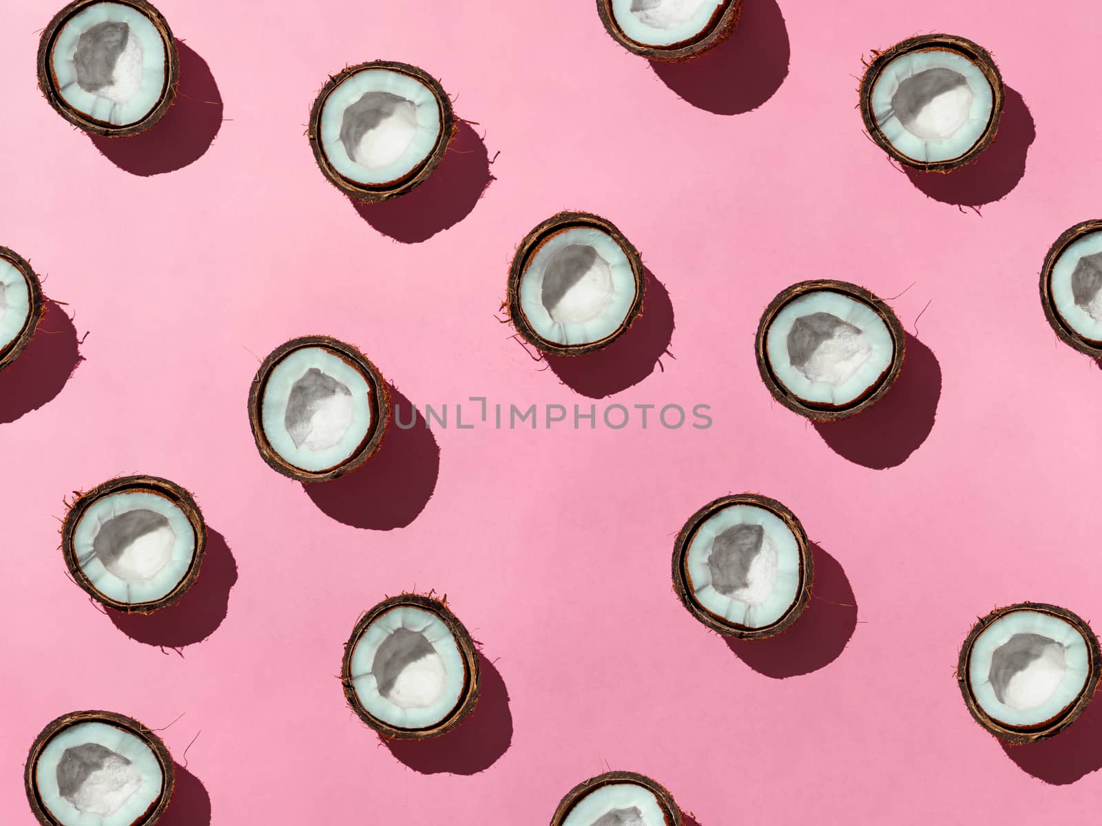 Coconuts half on pink background by fascinadora