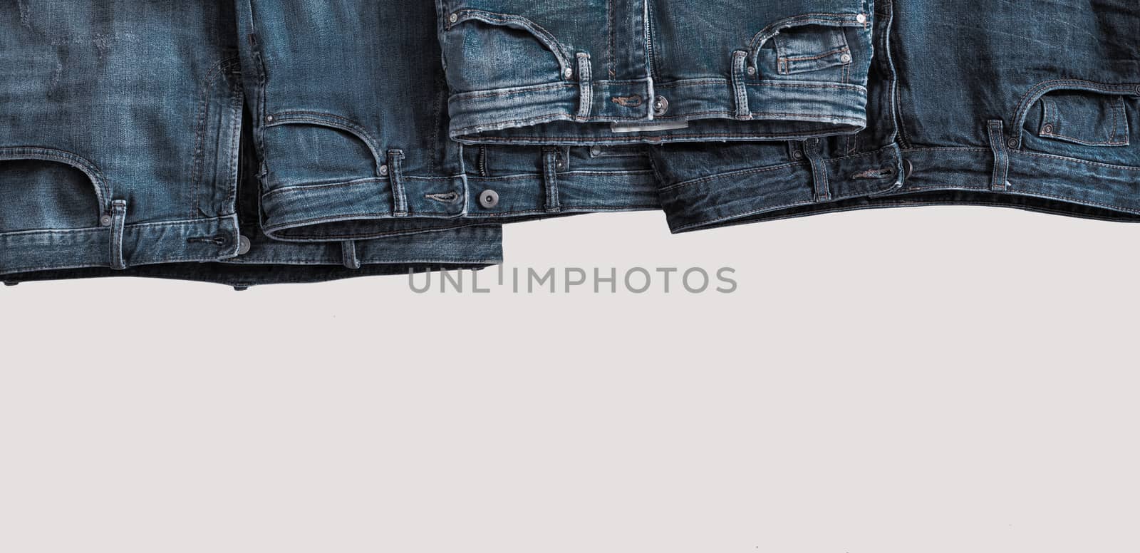 Jeans hang with copy space on bottom edge. Denim and jeans banner. Denim frame, text place for text. Jeans Casual Fashion banner for special offer or sale. Horizontal layout template with pants