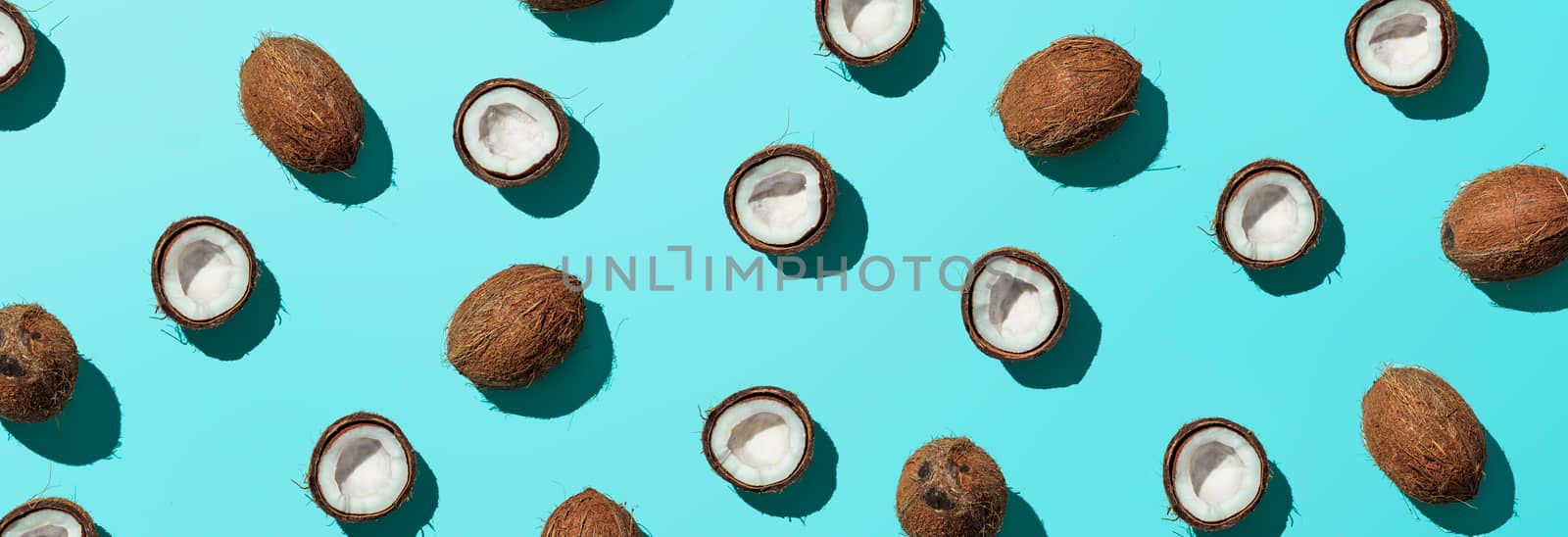 Coconuts half on blue background, banner by fascinadora