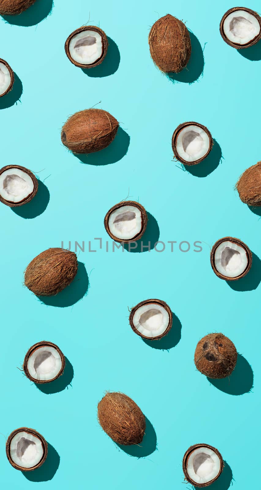 Coconuts half on blue background by fascinadora
