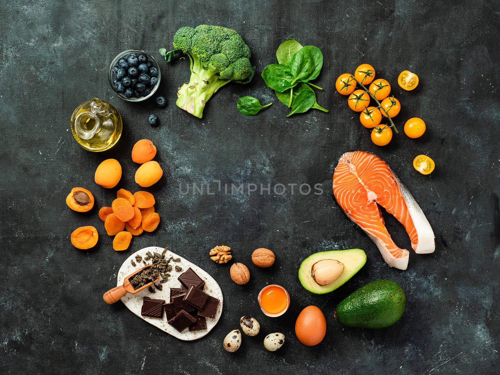 Brain food concept with copy space in center. Various food ingredients for thought with copy space in center over dark background. Top view or flat lay