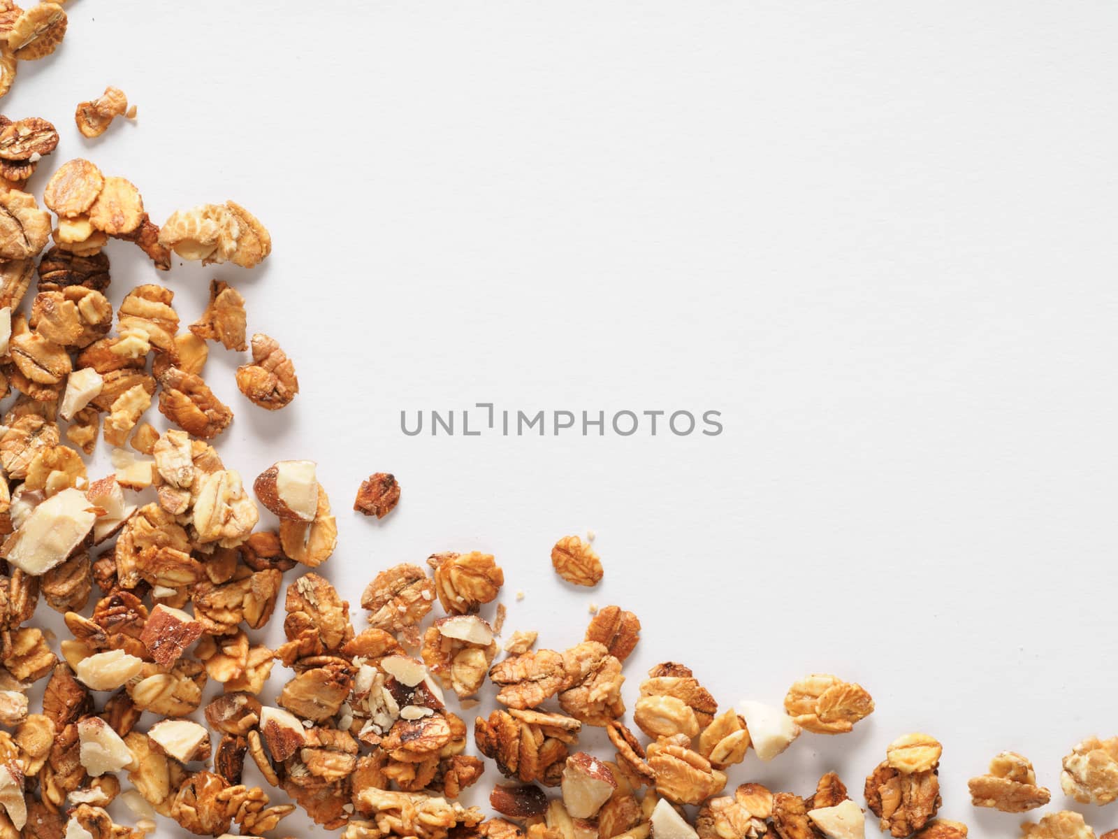 Homemade granola isolated one edge on white background. Ingredient for healthy breakfast. Copy space for text