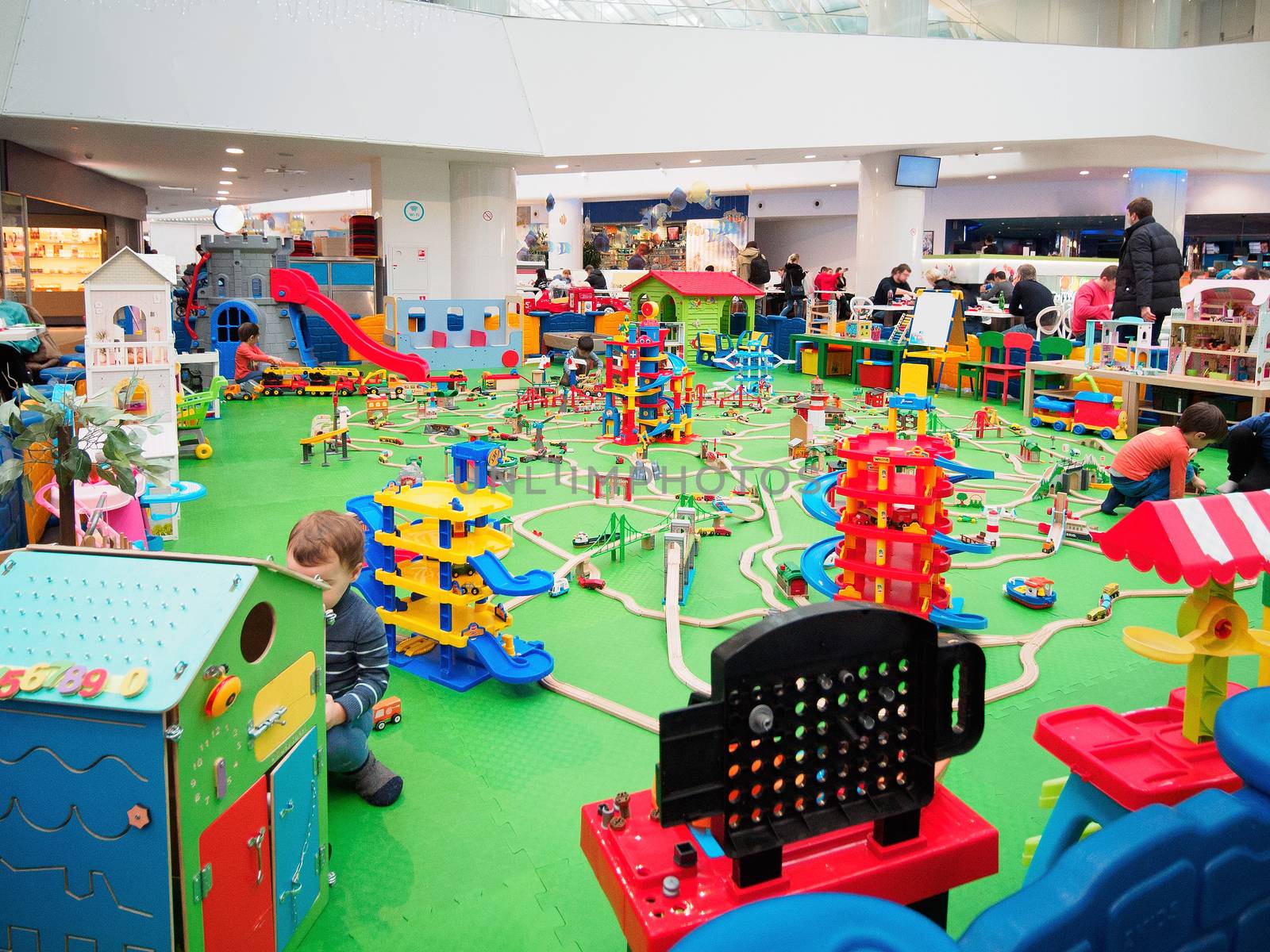 Kids playing in game zone in shopping mall. Play zone in modern shopping mall, kids zone. Copy space