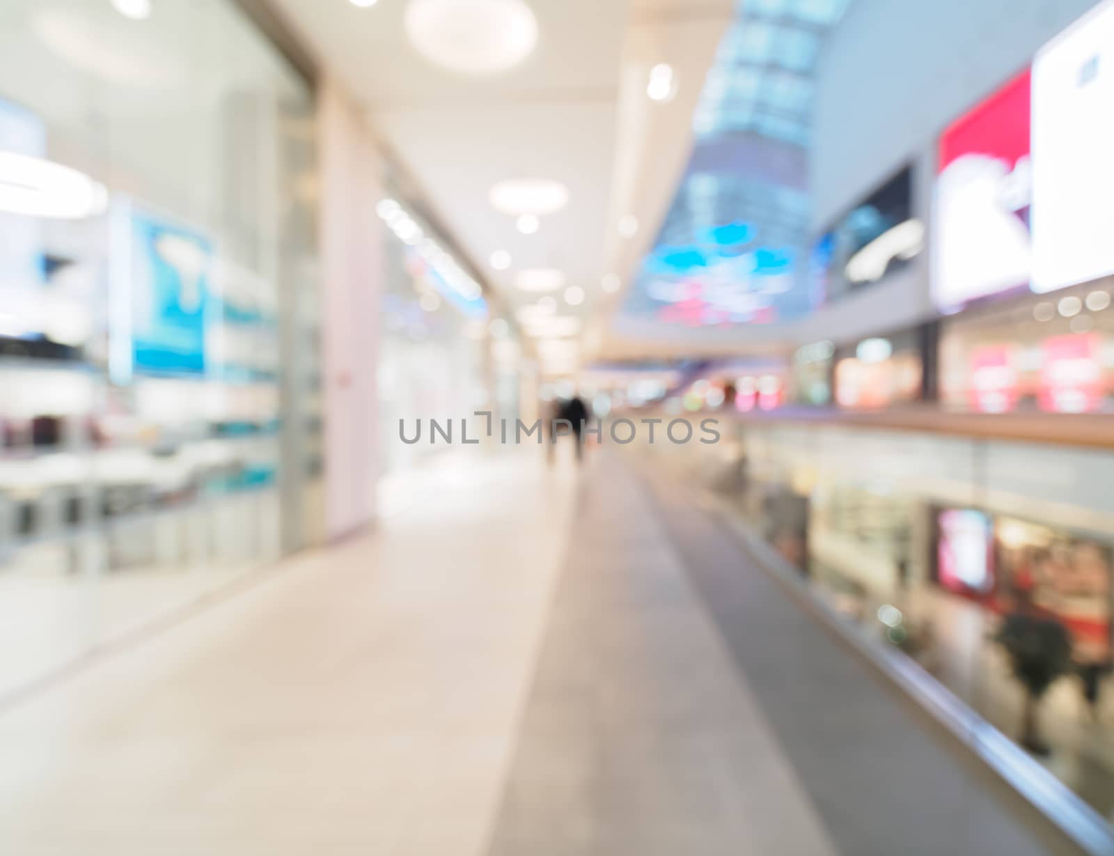 Shopping mall blur background with bokeh. Blurred hall of shopping mall with customers as background. Copy space