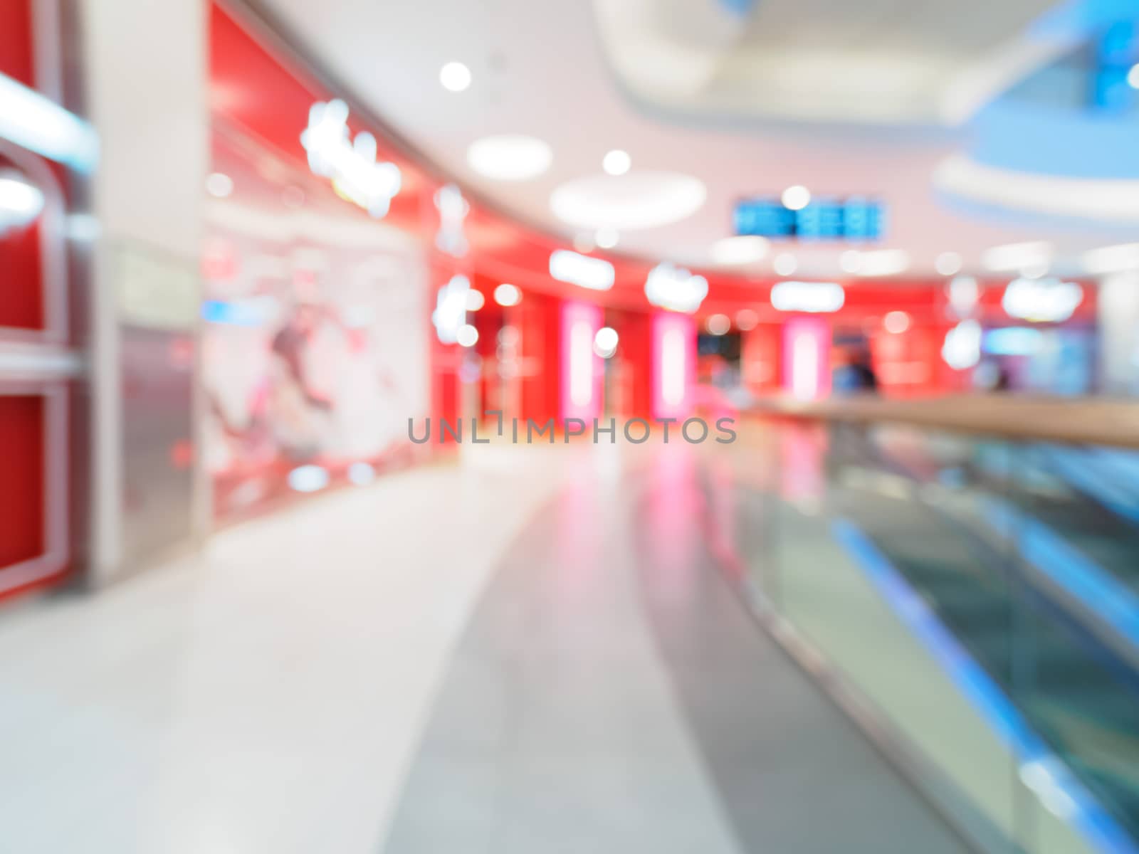 Shopping mall blur background with bokeh. Blurred hall of shopping mall with customers as background. Copy space