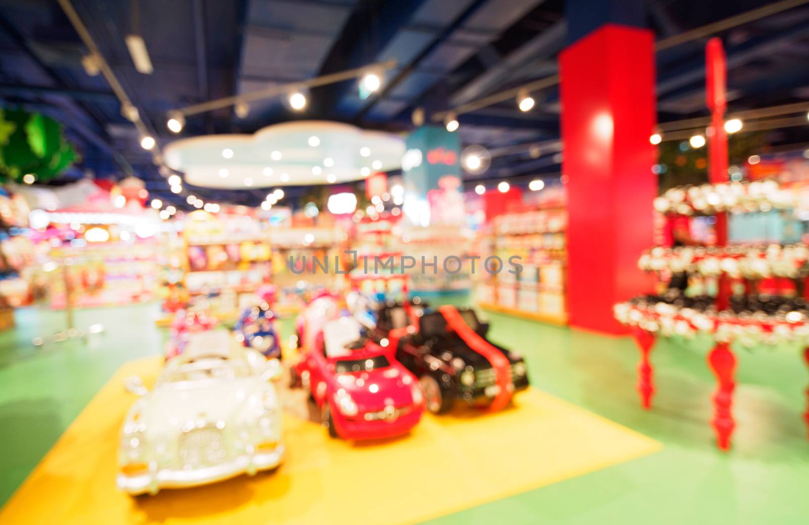 Blurred of kids toy store background with bokhe. shelves with cars and aisle of kids toy shop interior, copy space