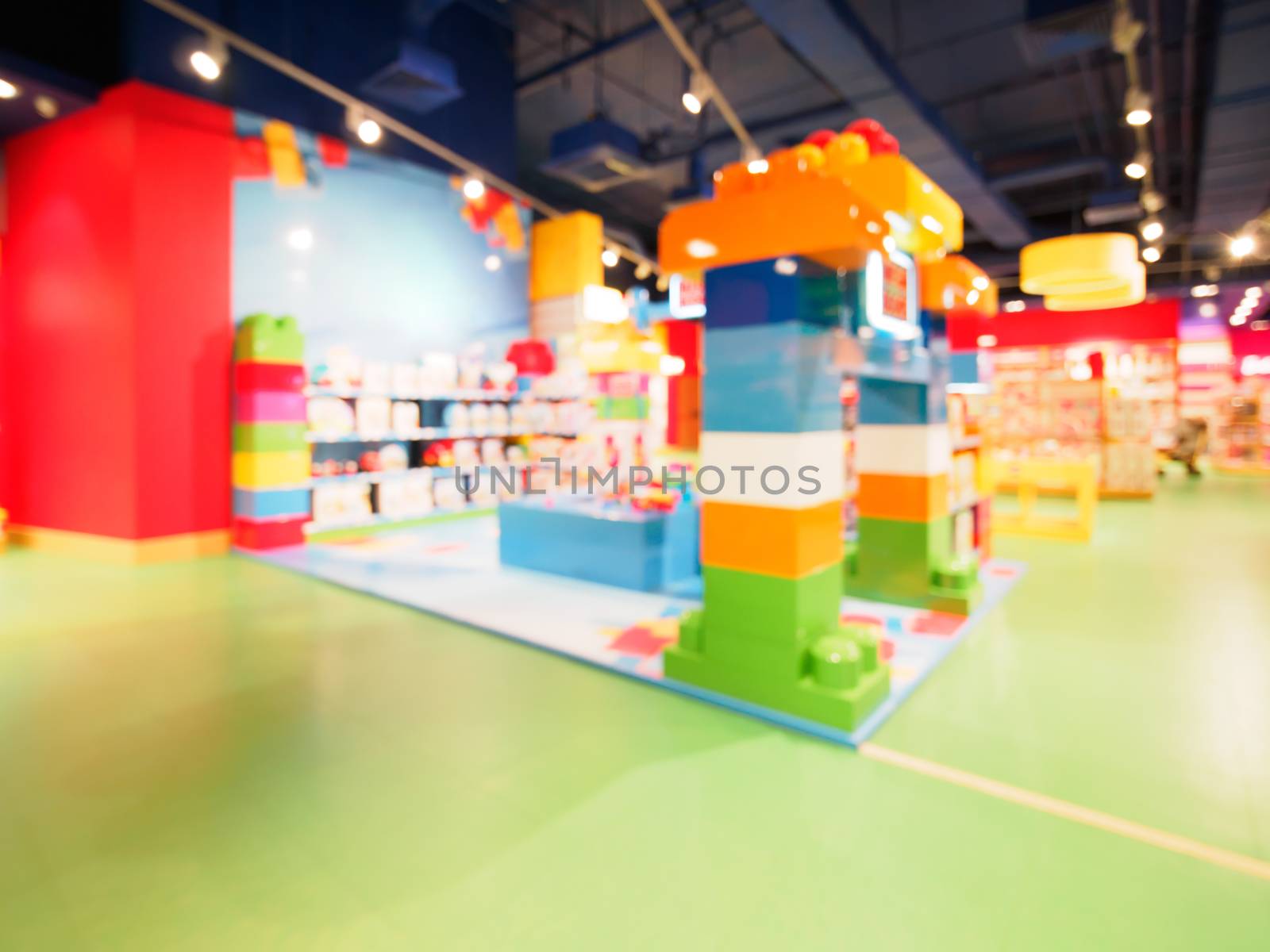 Blurred of kids toy store background with bokhe. Purple and yellow colors of toys shop interior, copy space