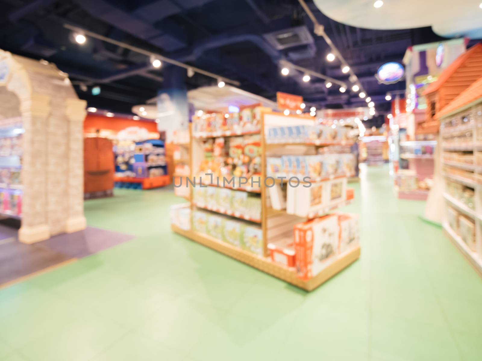 Blurred of kids toy store background with bokhe. Purple and yellow colors of toys shop interior, copy space