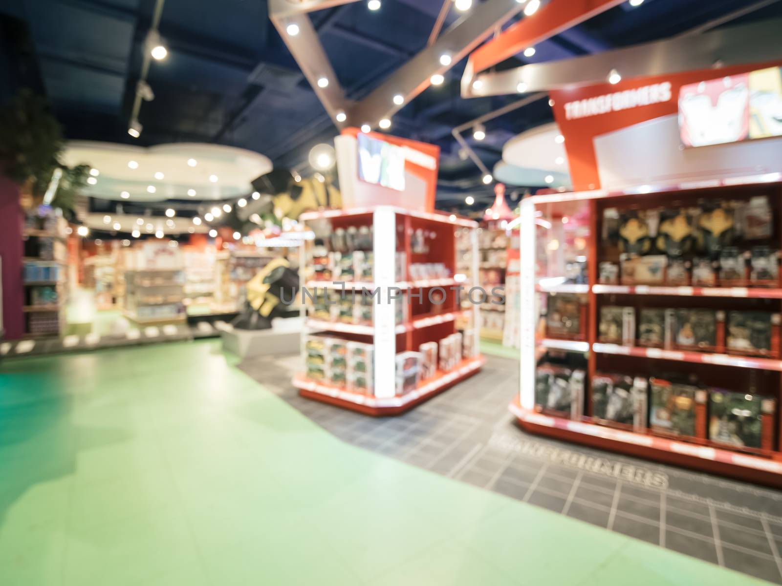 Blurred of kids toy store background with bokhe. Purple and yellow colors of toys shop interior, copy space