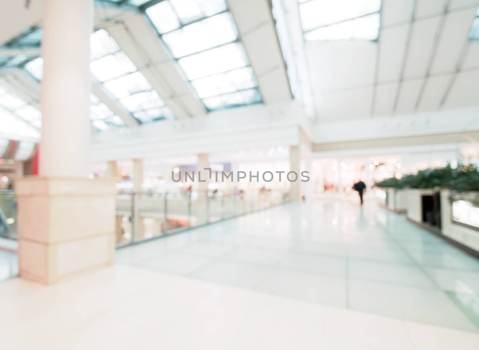 Shopping mall blur background with bokeh. Blurred hall of shopping mall with customers as background. Copy space