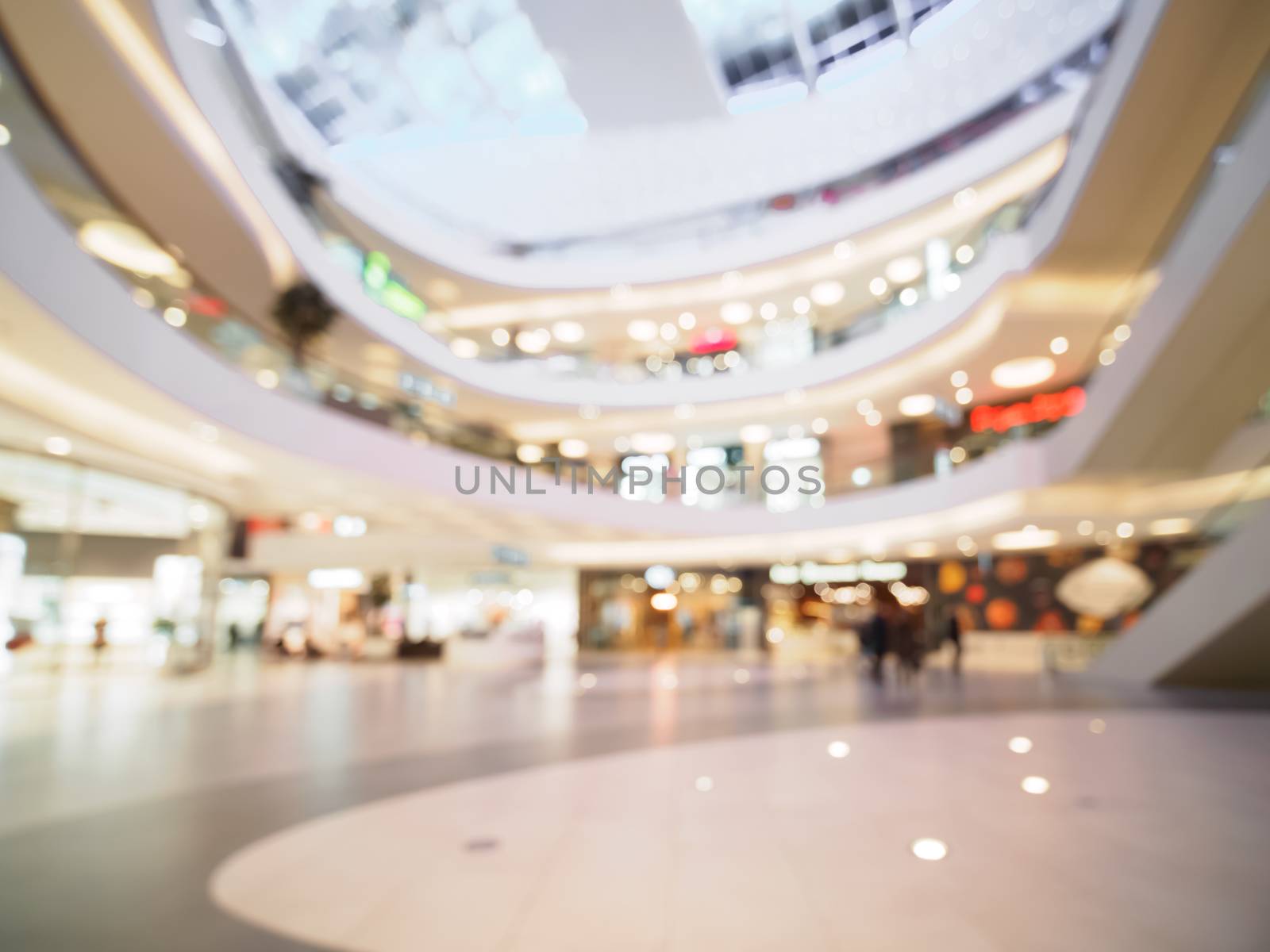 Shopping mall blur background with bokeh. Blurred hall of shopping mall with customers as background. Copy space