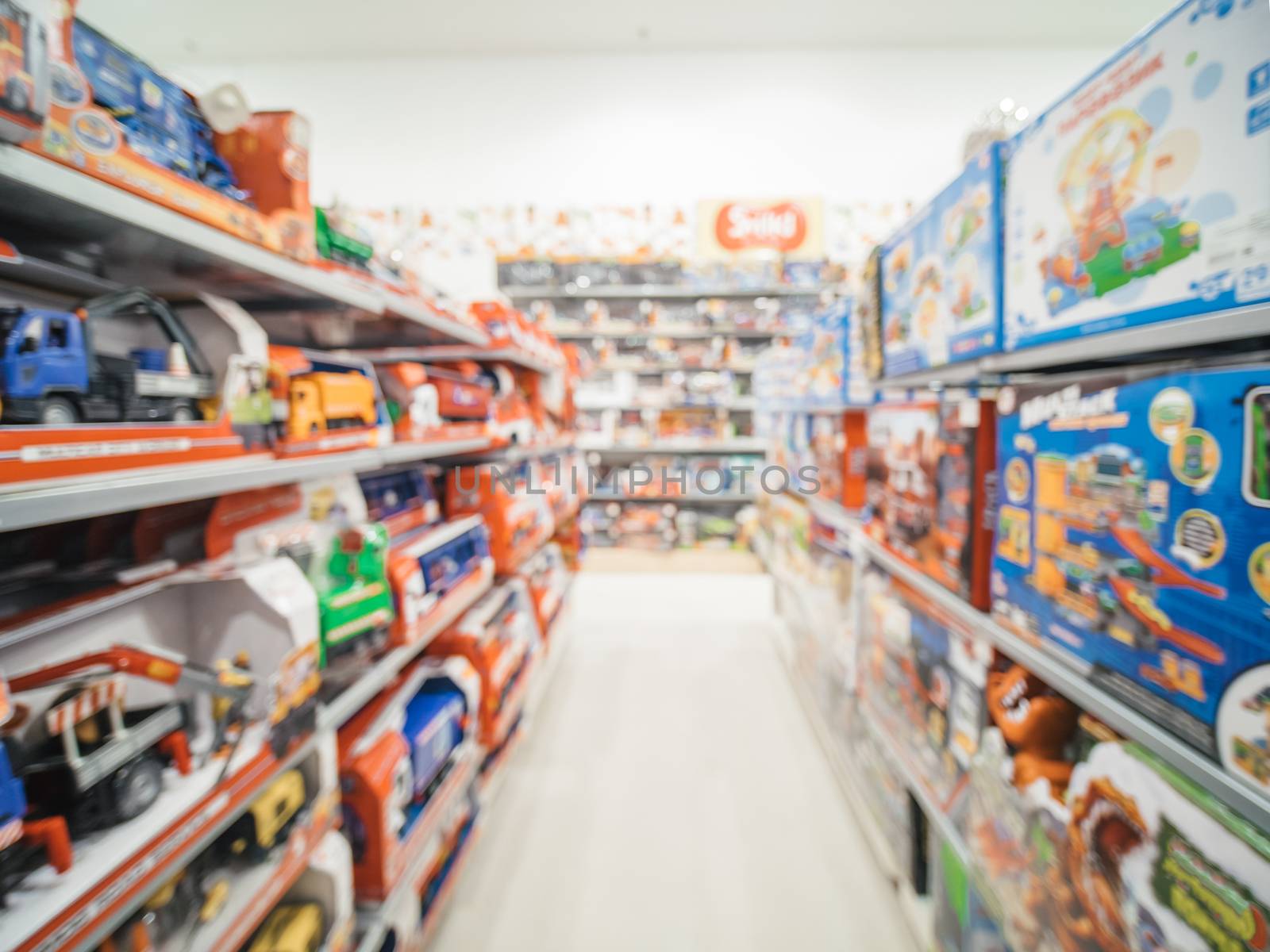 Blurred of kids toy store background with bokhe. shelves with cars and aisle of kids toy shop interior, copy space