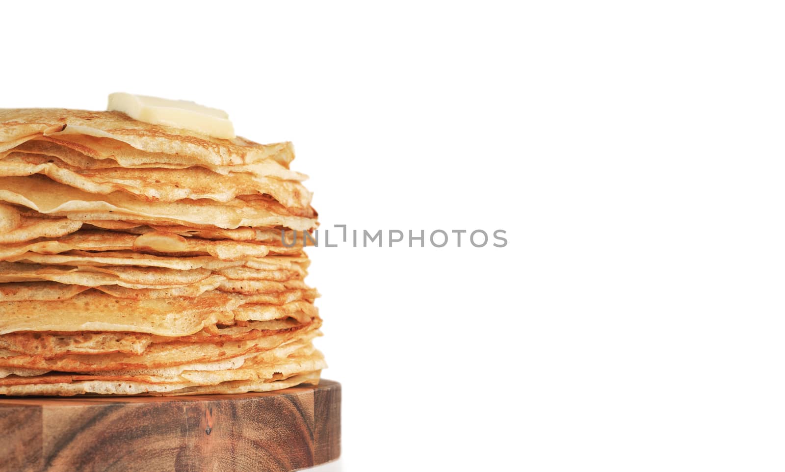 Stack of traditional russian pancakes blini isolated on white background with copy space. Homemade russian thin pancakes blini with butter piece. Russian food, russian kitchen
