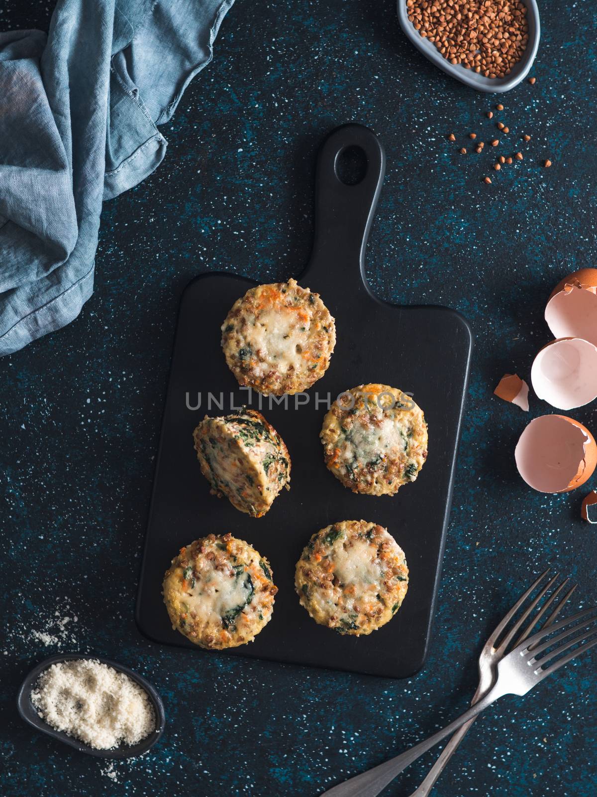 Buckwheat casserole with spinach,carrot,parmesan.Baked eggs with buckwheat,vegetables and cheese.Ideas and recipes healthy easy breakfast,lunch,kids meal,snack - vegetables muffins.Copy space.Top view