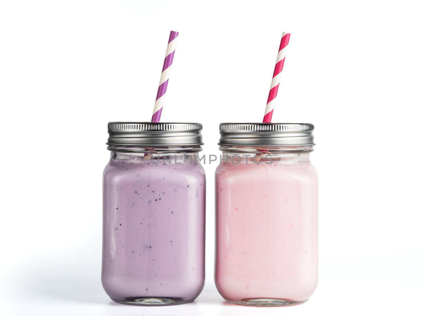 Strawberry and blueberry smoothie in mason jar glass. Isolated on white with clipping path.