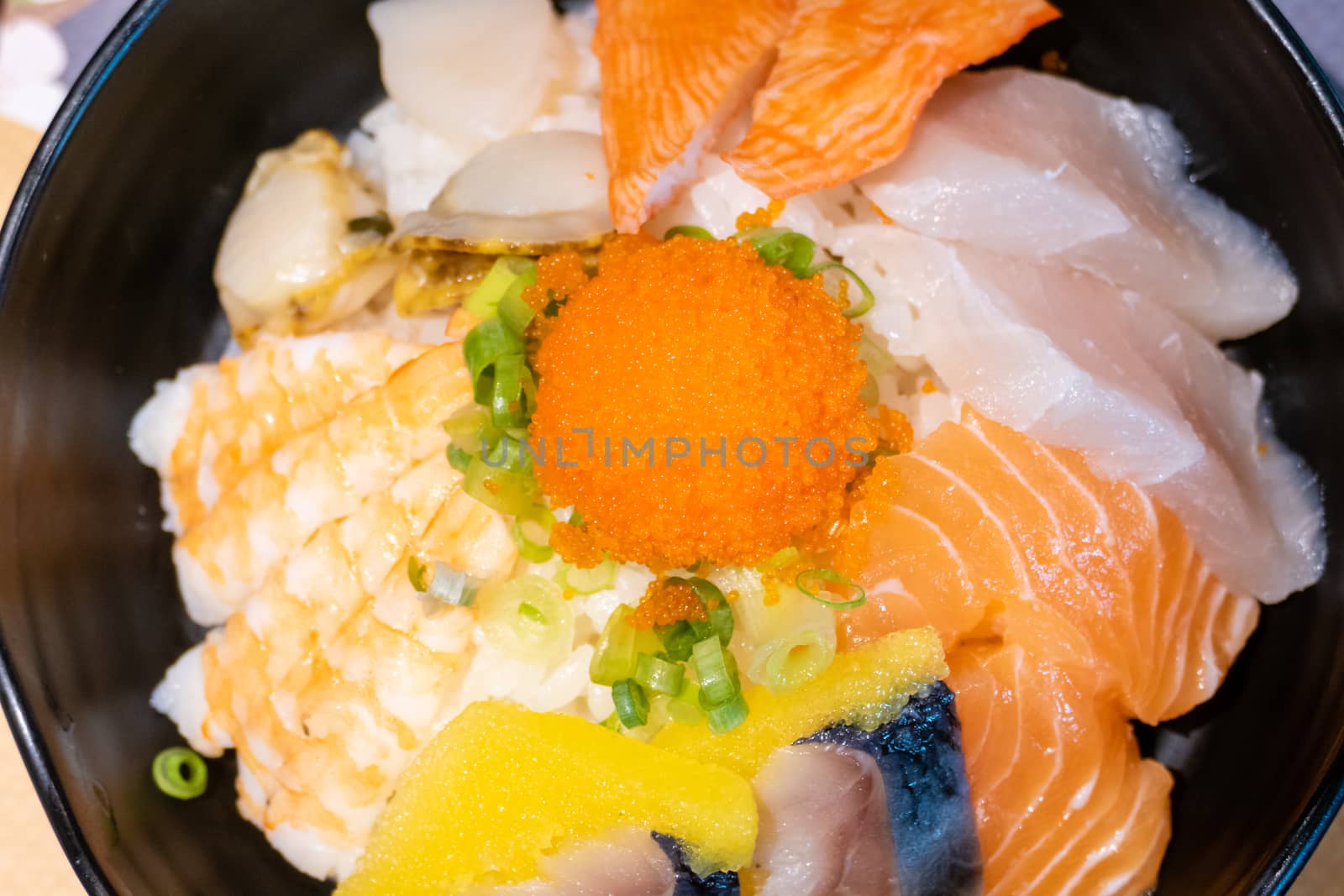 Sashimi in bowl with fish eggs and rice