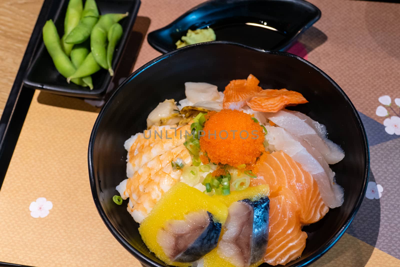 Sashimi in bowl with fish eggs and rice