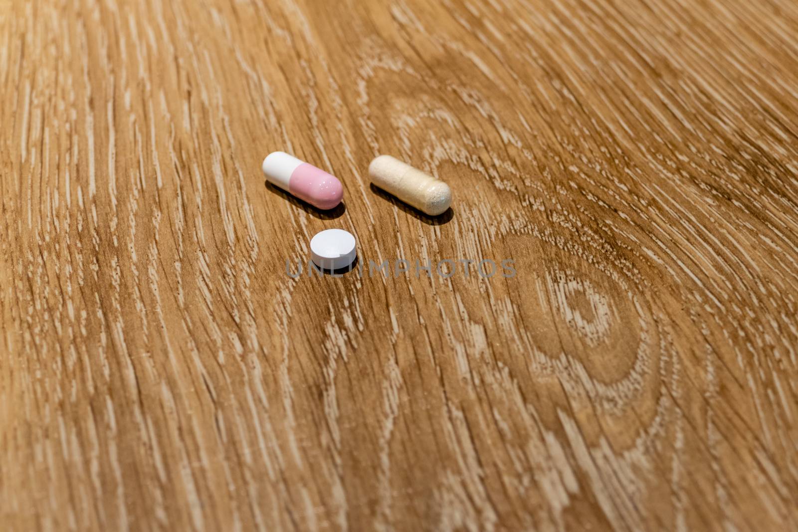 Capsules and pill on table, medical concept