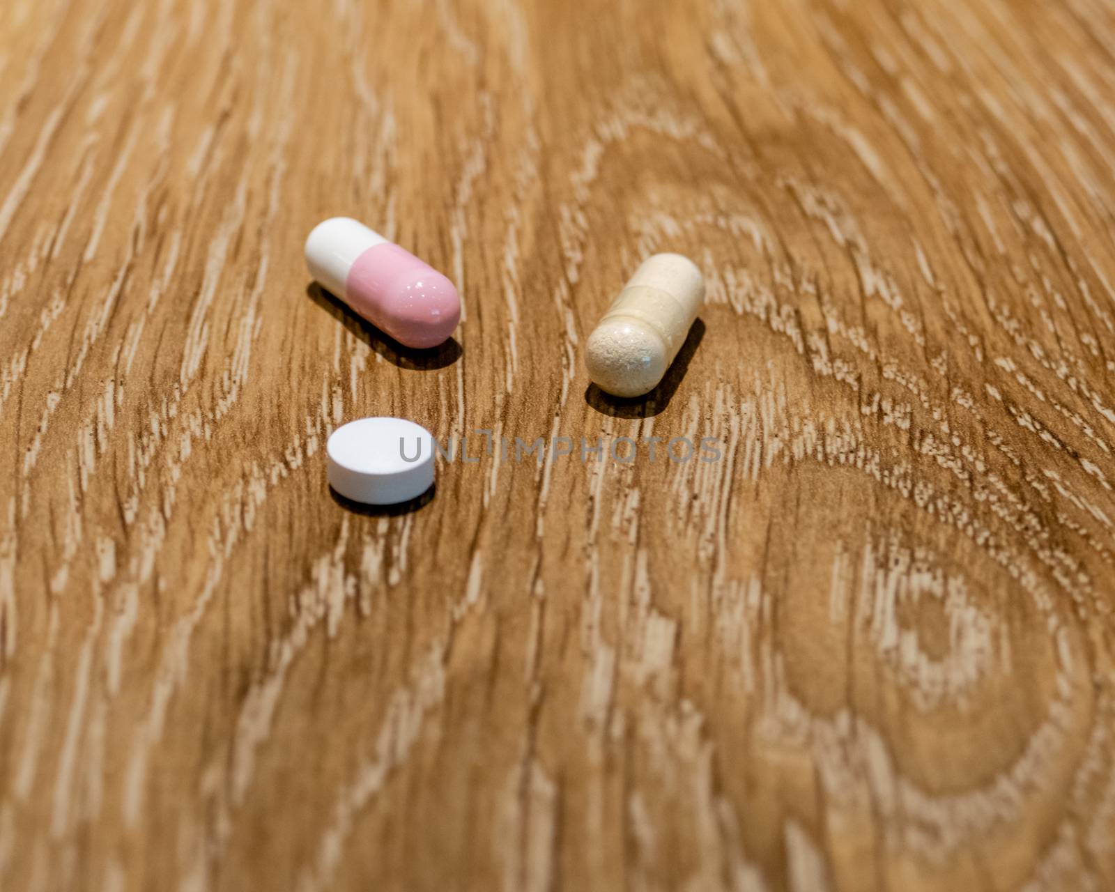 Capsules and pill on table, medical concept