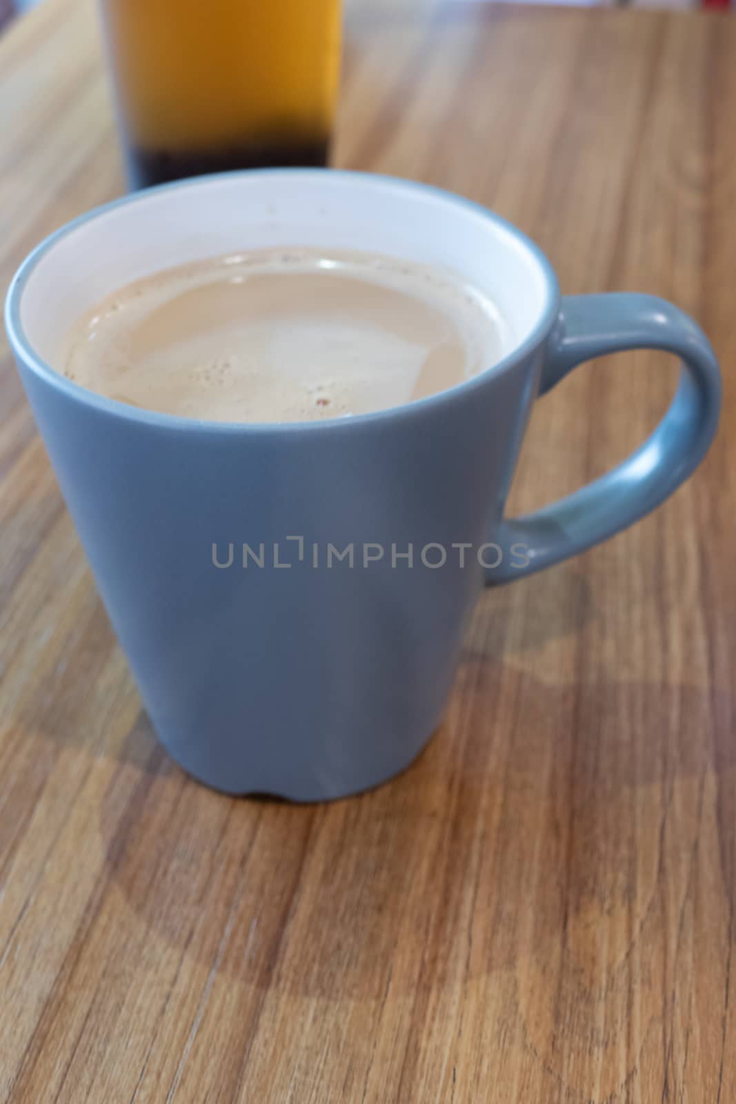 Coffee with milk in mug on table