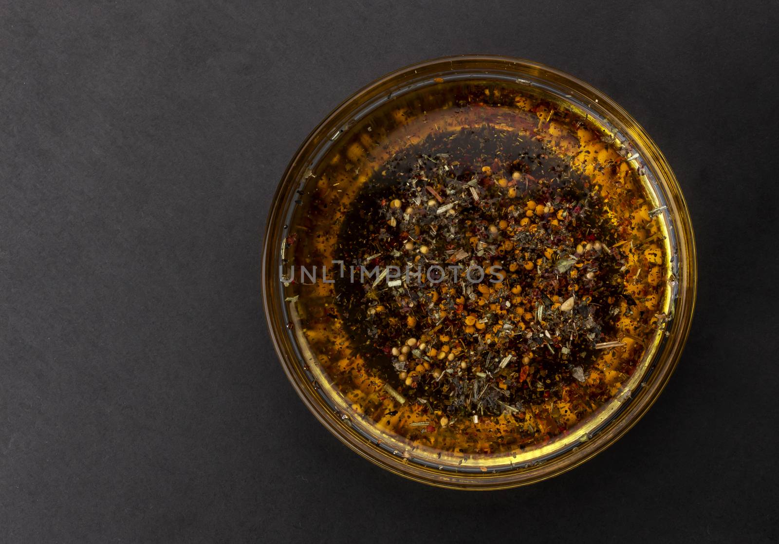 Oil salad dressing isolated on black background, top view by xamtiw