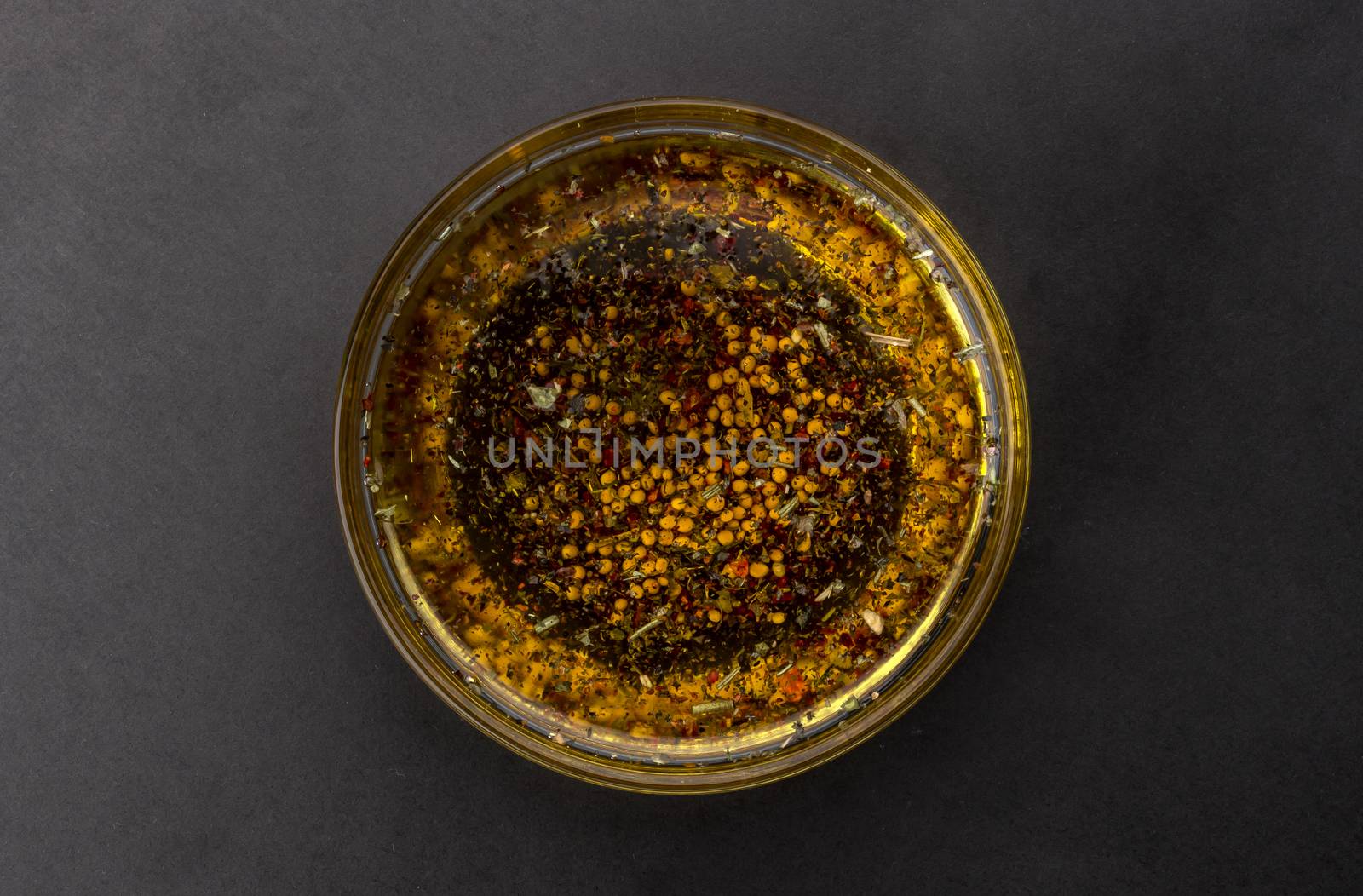 Oil salad dressing isolated on black background, top view by xamtiw