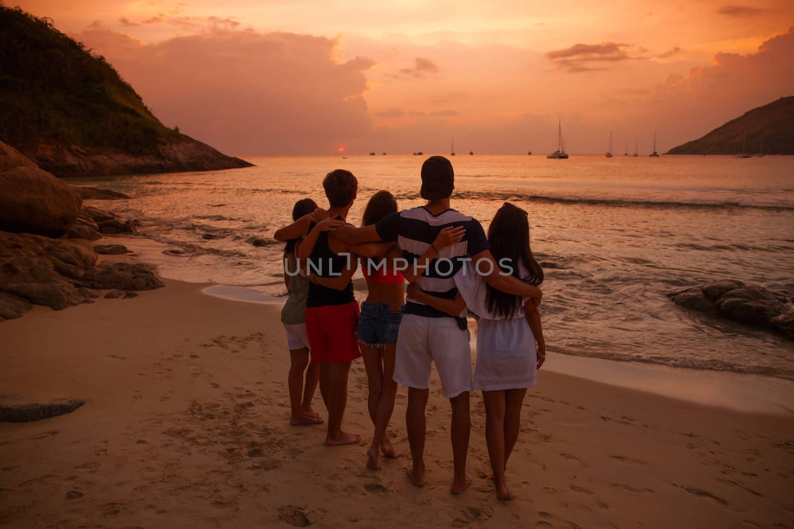 Friends on beach at sunset by ALotOfPeople
