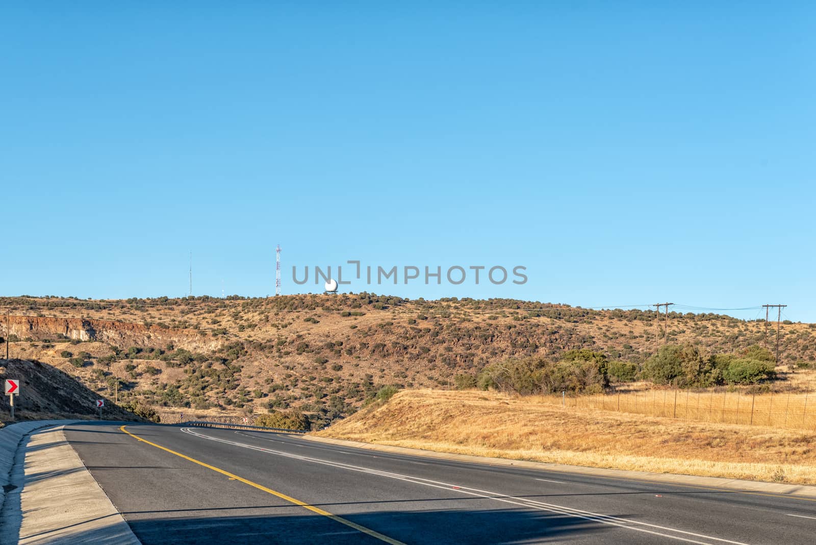 A view of the N8-road to the west of Bloemfontein in the Free State Province of South Africa. A weather radar system and cellphone tower is visible