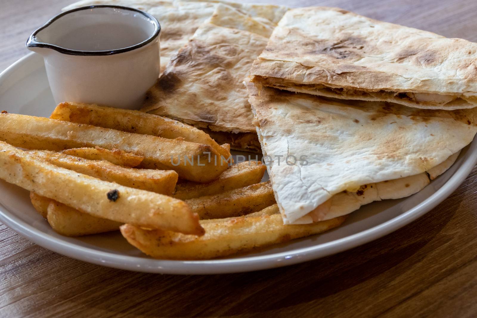 Quesadilla and french fries on plate