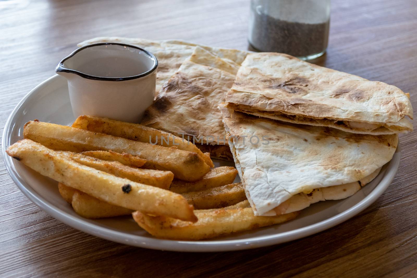 Quesadilla and french fries on plate