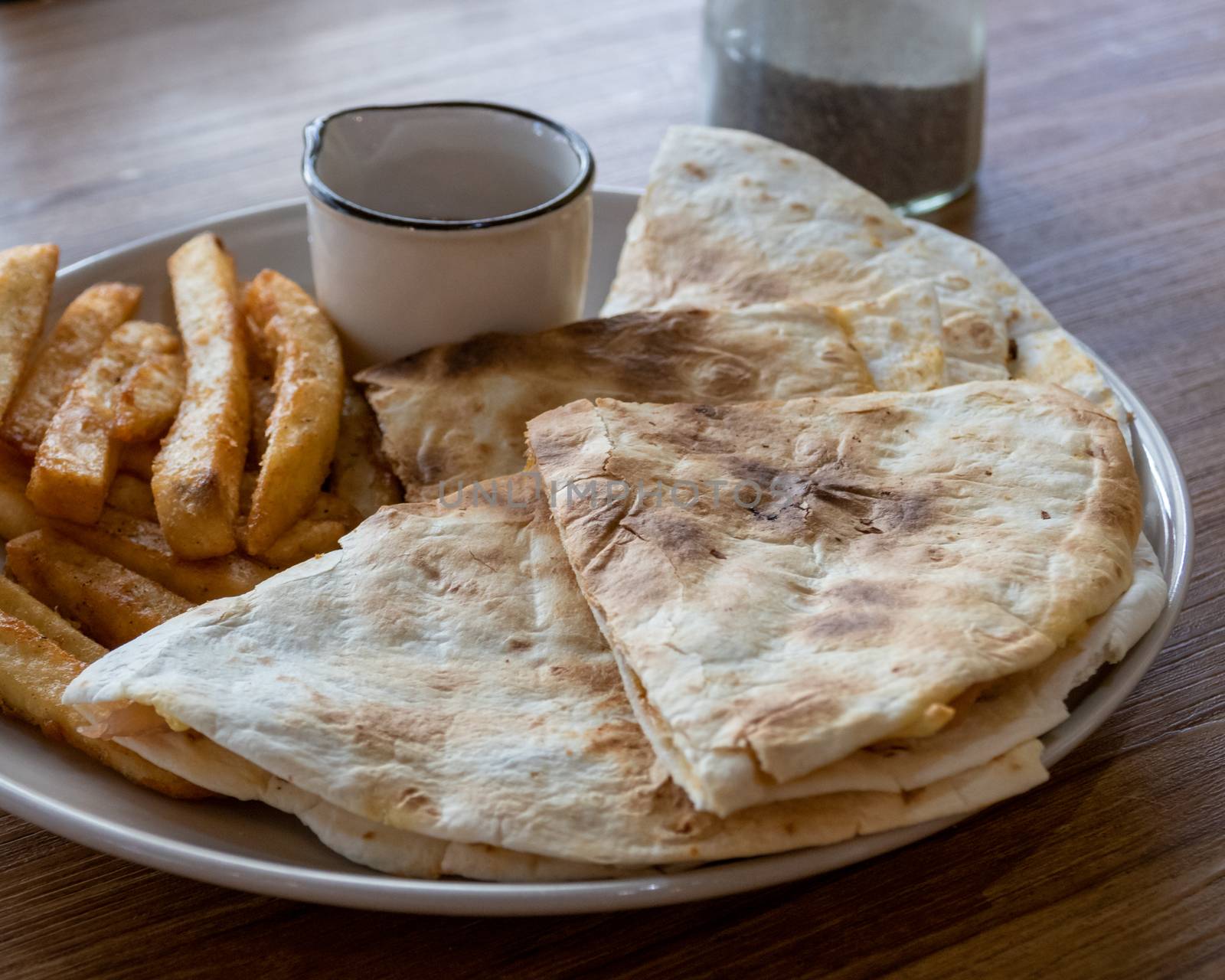 Quesadilla and french fries on plate