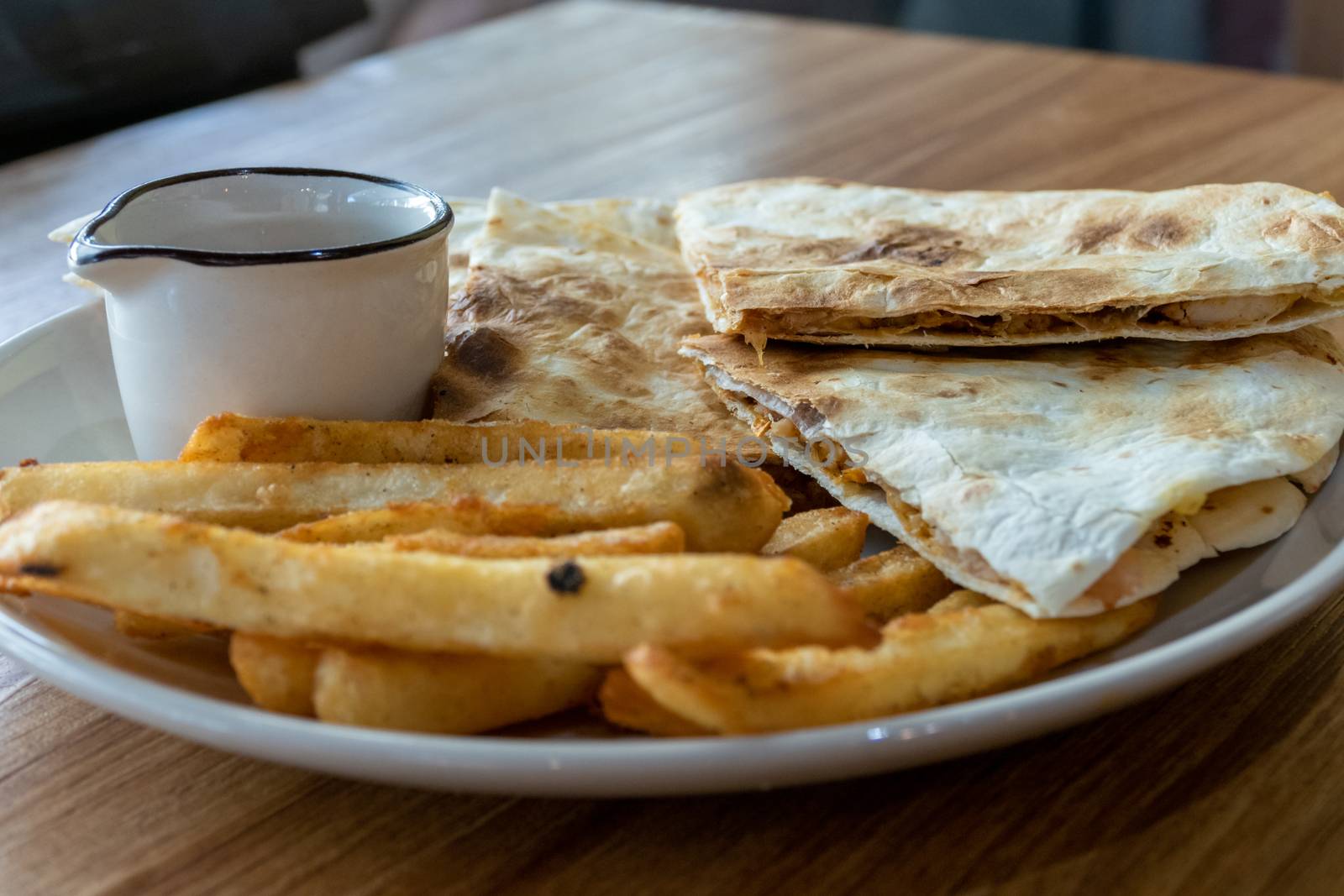 Quesadilla and french fries on plate