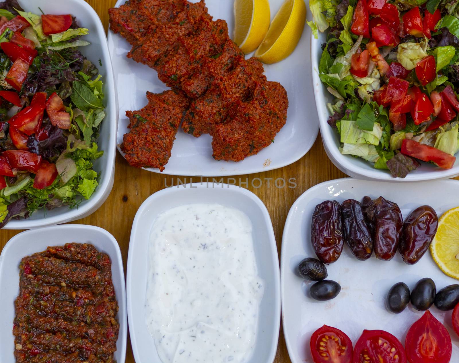 appetizer table. The background consisting of salad, yogurt, olives, raw meatballs and appetizers.  Organic food background. isolated wooden background. "haydari"