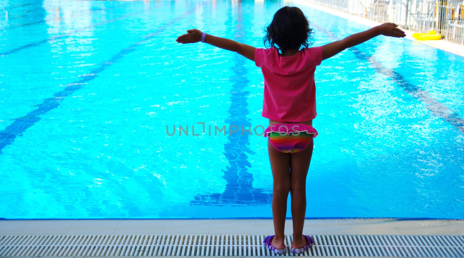 Little girl at the hotel pool. The enjoyment of summer vacation. Very happy