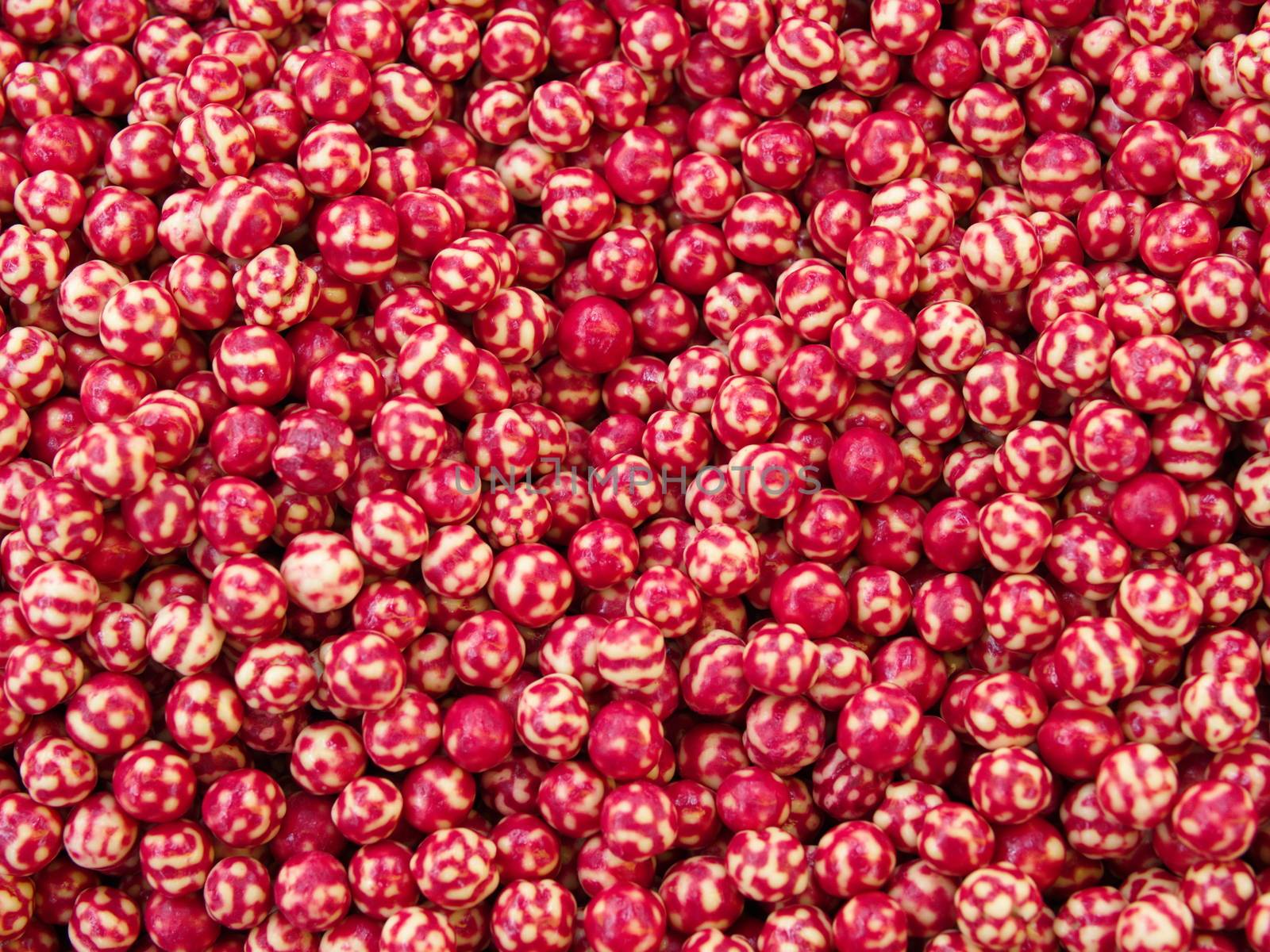 Roasted chickpeas covered in chocolate, cherry sauce.  top view organic cookie background