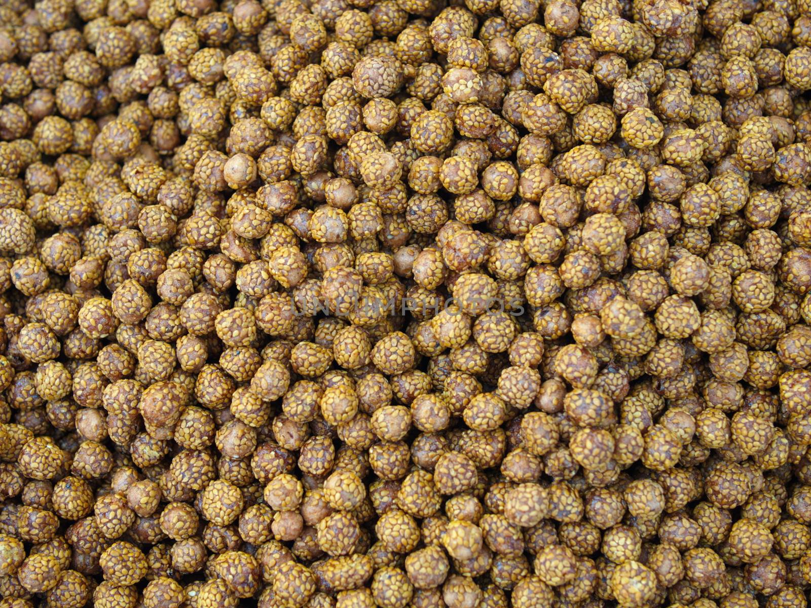 sesame seeds, honey and sugar coated roasted chickpea. top view organic cookie background