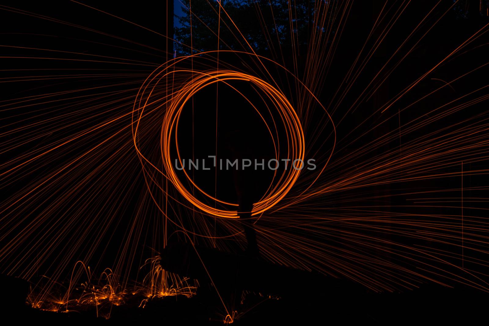 Drawing light at night in an old abandoned building, splashes of light and sparks. Freezelight