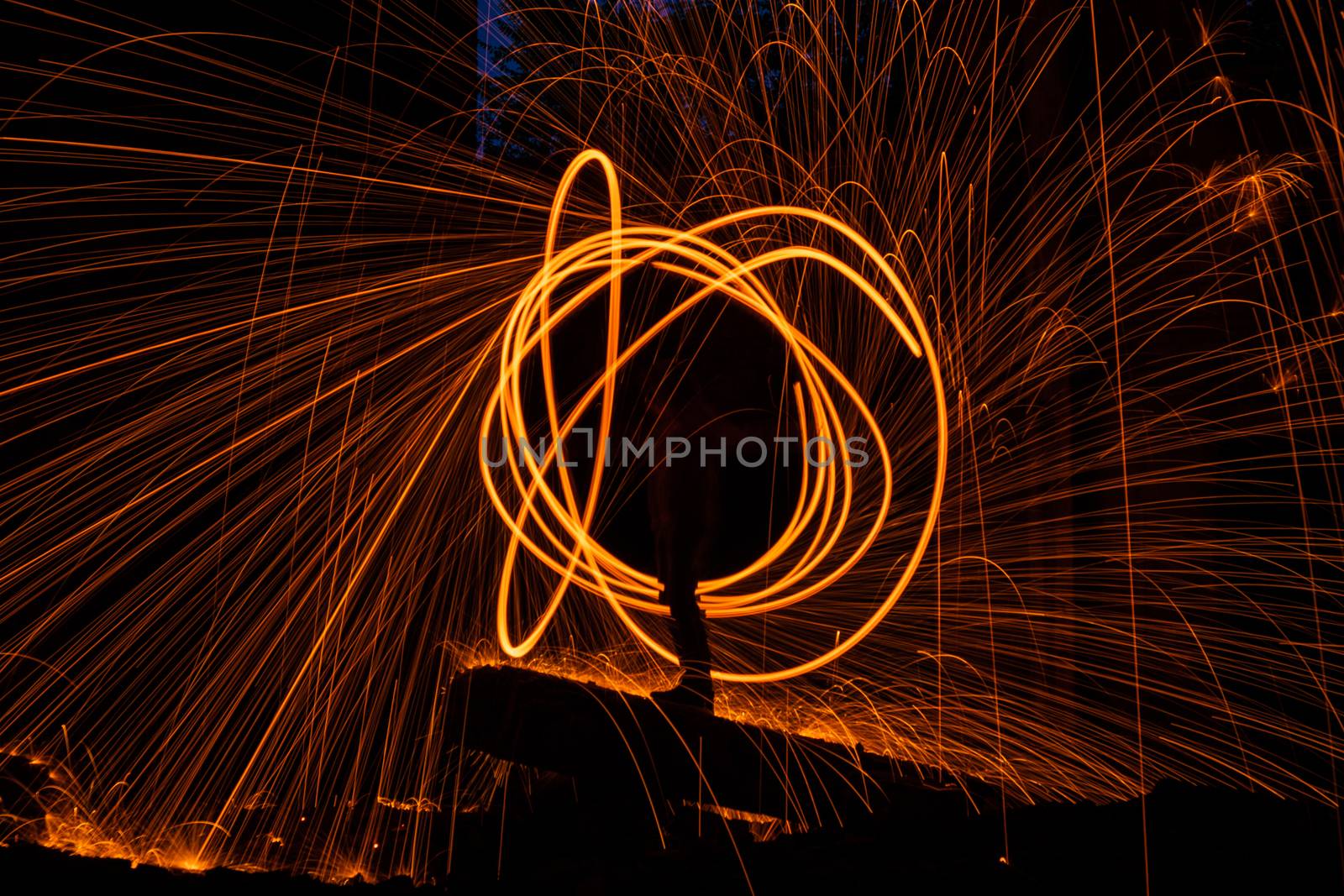 Drawing light at night in an old abandoned building, splashes of light and sparks. Freezelight